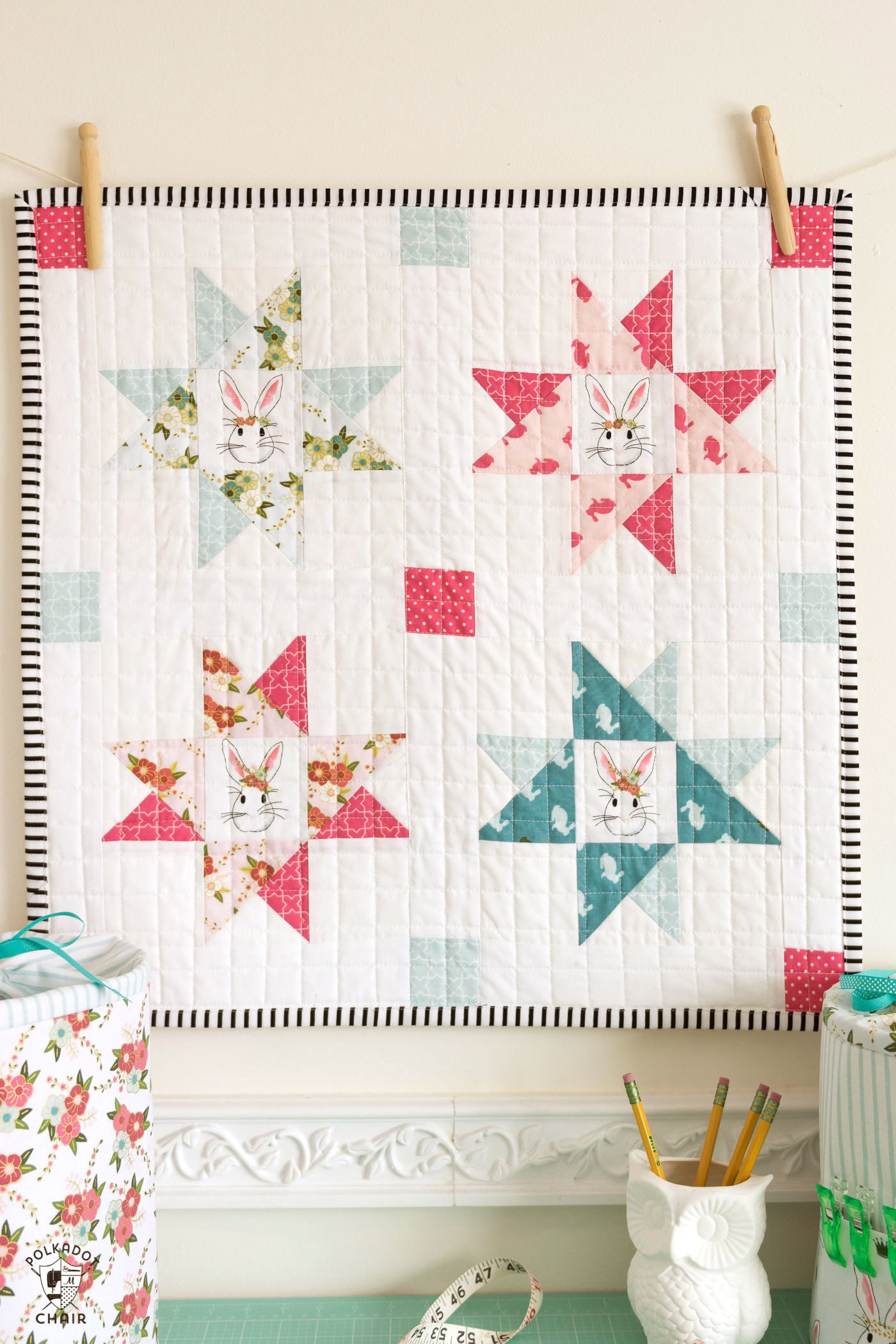 Easter themed quilt hanging from white wall