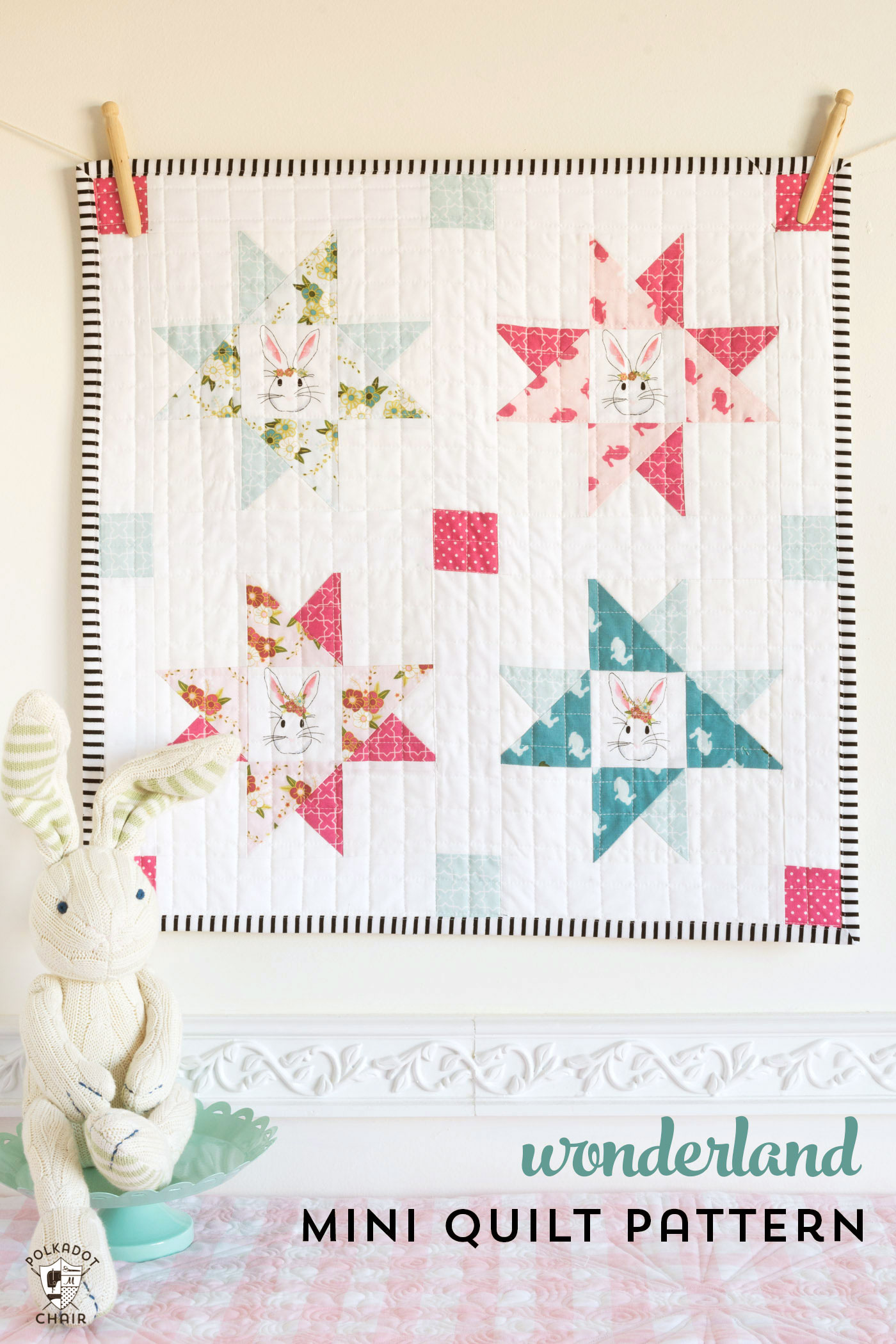 Easter themed quilt hanging from white wall.