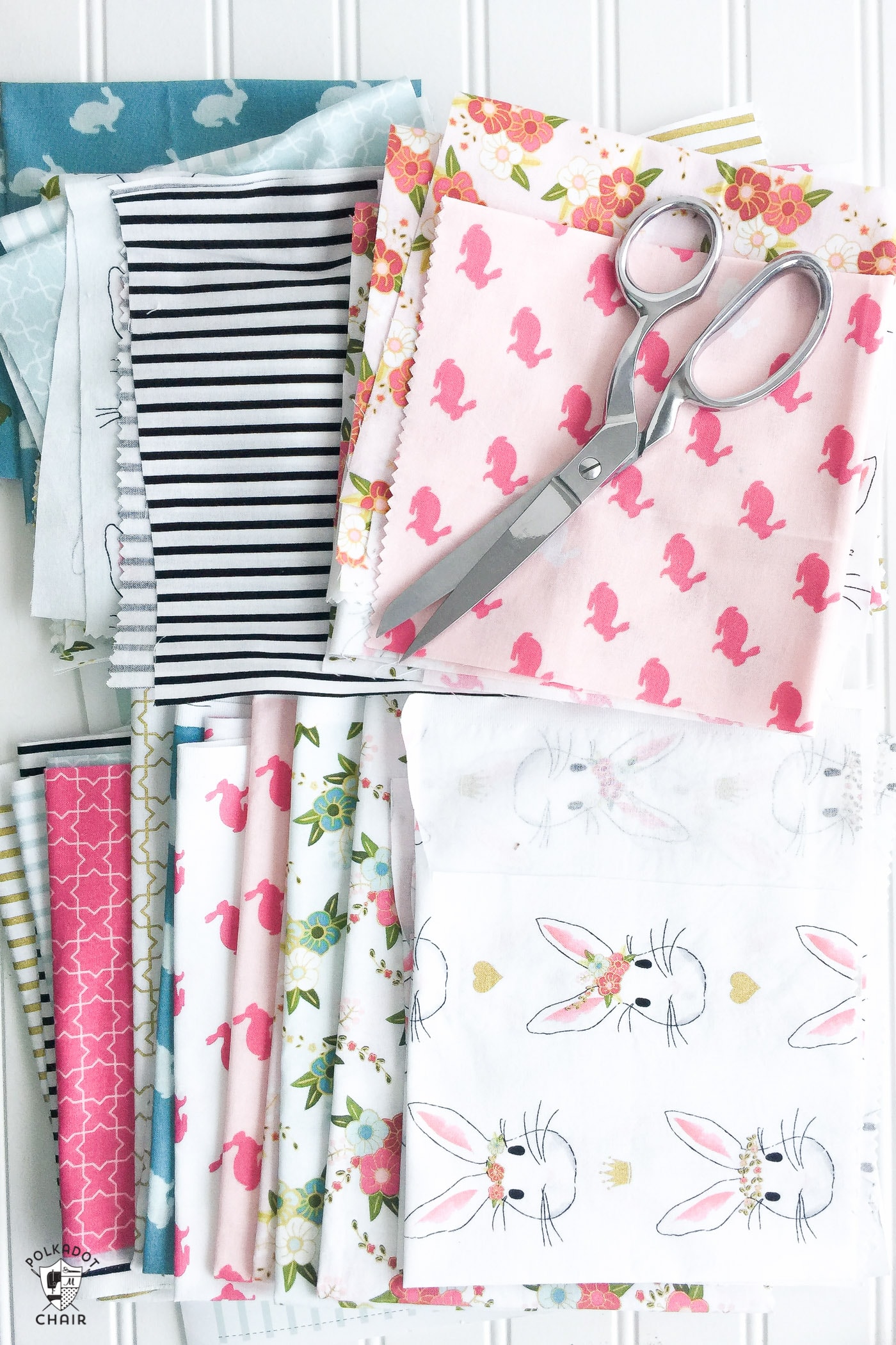 Scissors on top of a stack of fabric.