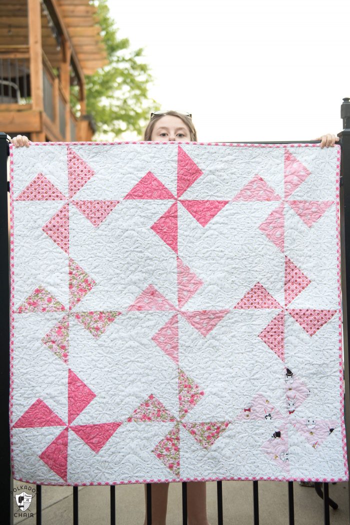 Free baby quilt patterns including this one for a simple baby quilt made using a Turnstile Quilt block! So easy you could make it in a day.