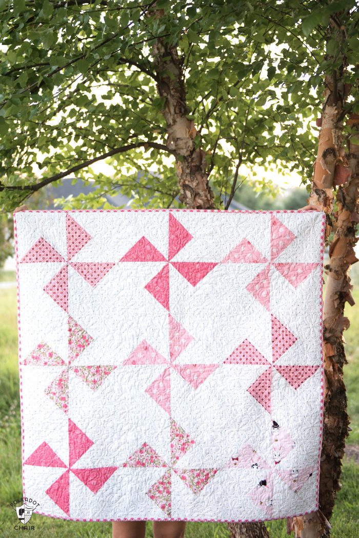 Free baby quilt patterns including this one for a simple baby quilt made using a Turnstile Quilt block! So easy you could make it in a day.