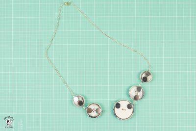 Make a cute statement necklace with this fabric covered button necklace tutorial by Melissa Mortenson of polkadotchair.com