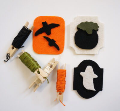 orange and black felt with halloween shapes on white table