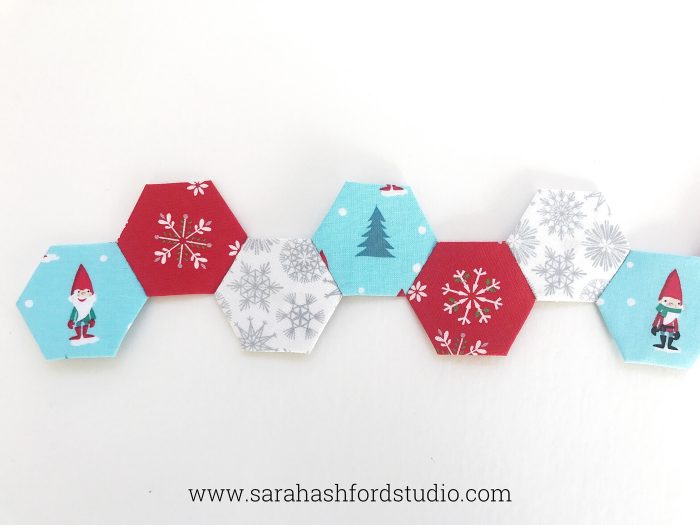 Super cute Christmas Hexie Tea Towel tutorial by Sarah Ashford. Such a fun Christmas gift idea ; learn how to sew hexagons! #christmasgifts #christmassewing #hexies #hexagons #hexagontutorial #christmasfabric #teatowel