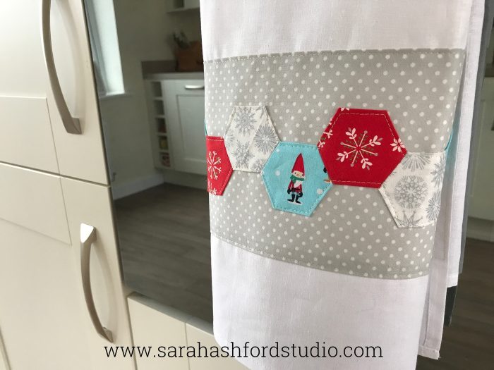 Super cute Christmas Hexie Tea Towel tutorial by Sarah Ashford. Such a fun Christmas gift idea ; learn how to sew hexagons! #christmasgifts #christmassewing #hexies #hexagons #hexagontutorial #christmasfabric #teatowel