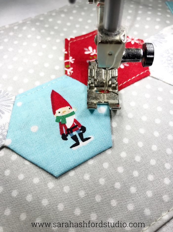 Super cute Christmas Hexie Tea Towel tutorial by Sarah Ashford. Such a fun Christmas gift idea ; learn how to sew hexagons! #christmasgifts #christmassewing #hexies #hexagons #hexagontutorial #christmasfabric #teatowel