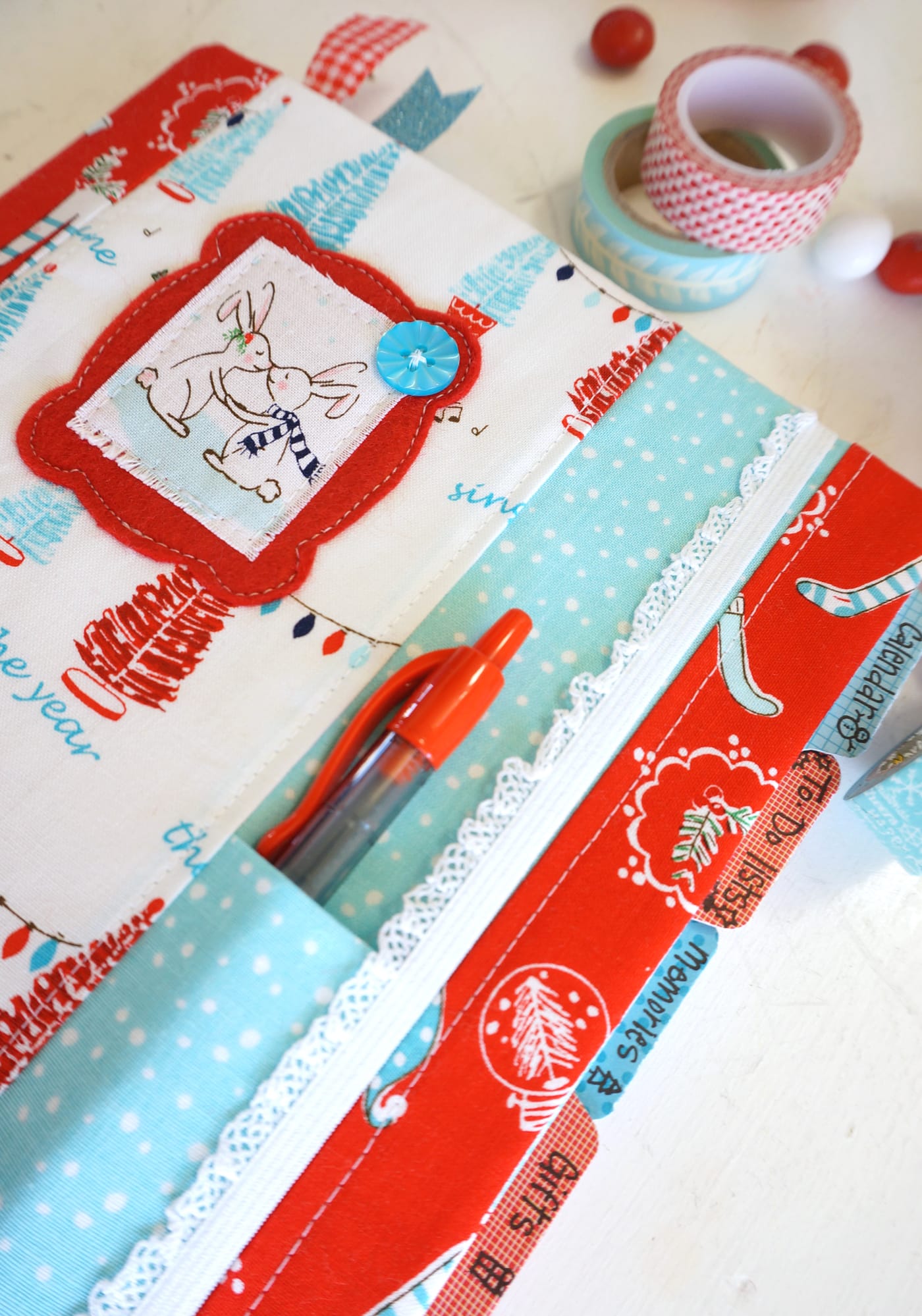 Red pin in red and blue fabric planner.