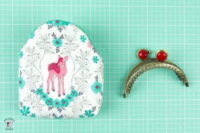 small sewn coin purse and metal frame on cutting mat
