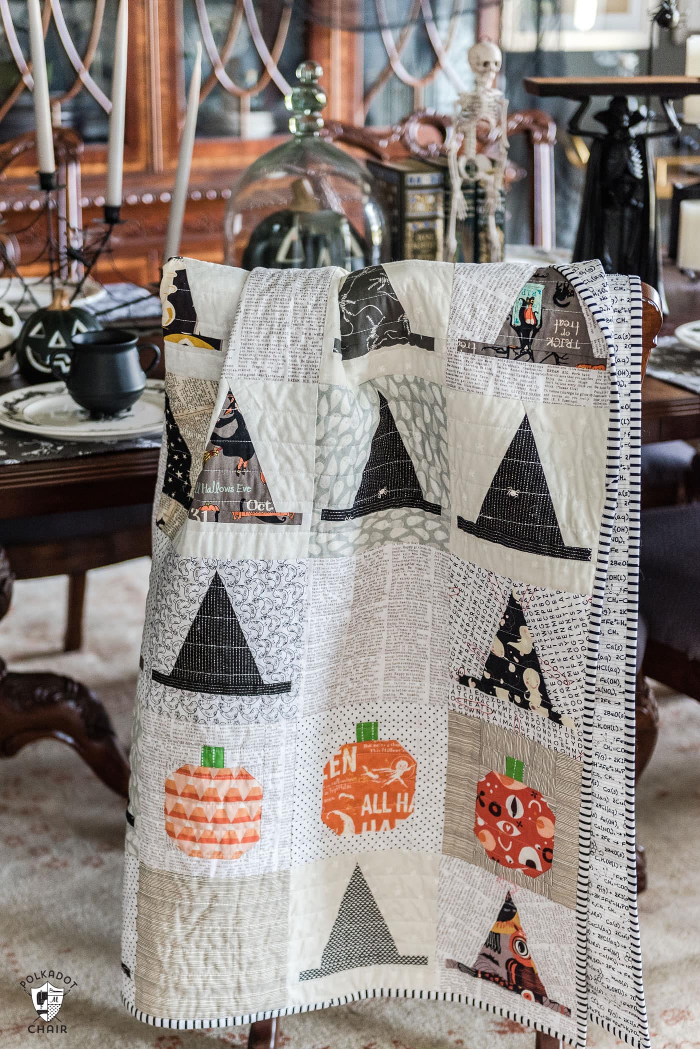 Halloween Haberdashery Quilt by Melissa Mortenson -  hanging on chair in gray dining room