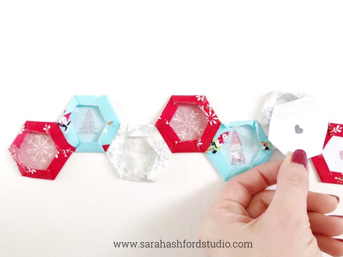 Super cute Christmas Hexie Tea Towel tutorial by Sarah Ashford. Such a fun Christmas gift idea ; learn how to sew hexagons! #christmasgifts #christmassewing #hexies #hexagons #hexagontutorial #christmasfabric #teatowel