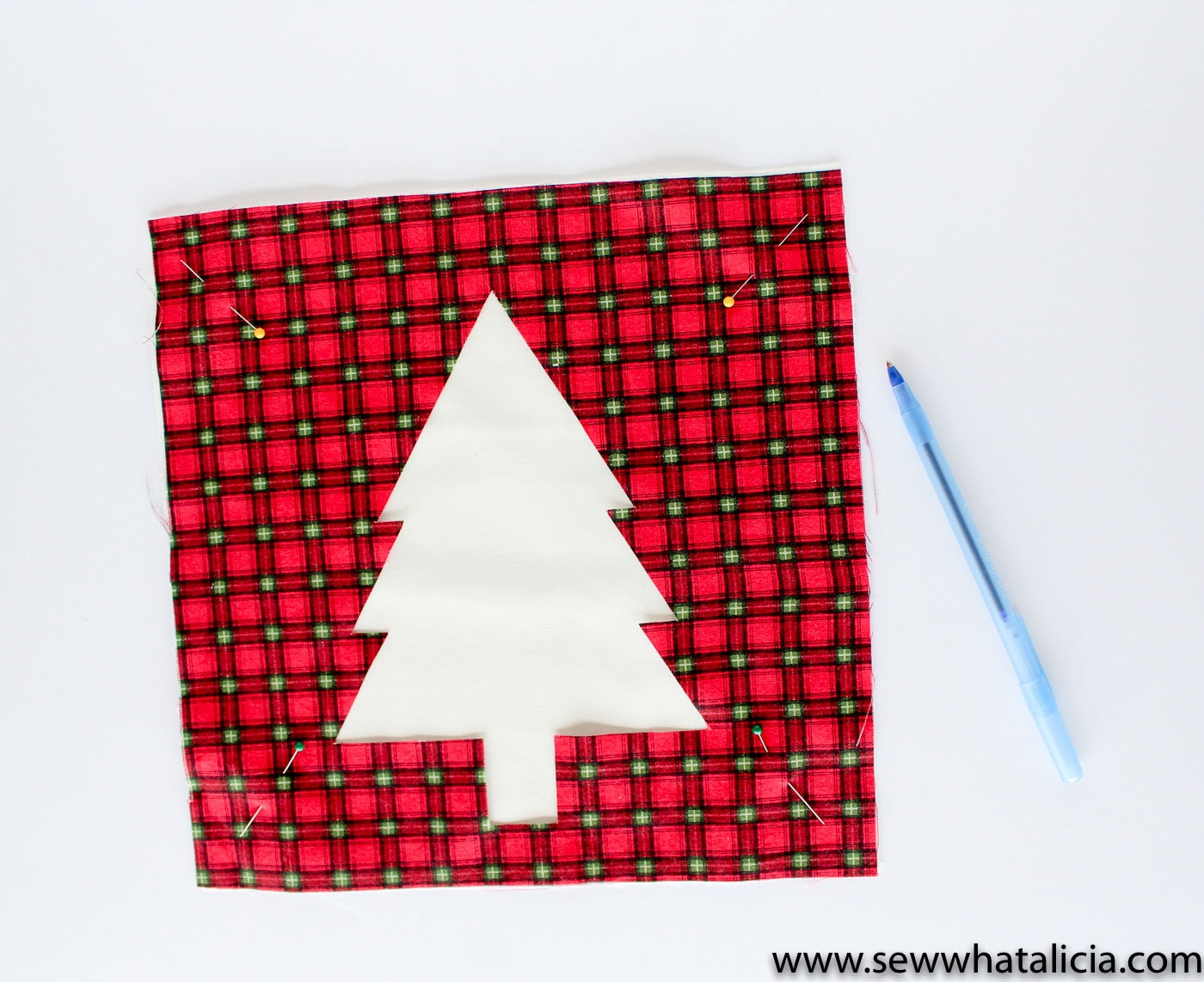 Free Reverse Applique Christmas Table Runner Pattern - such a cute and fun Christmas craft or sewing project #tablerunner #tablerunnerpattern #christmas #ChristmasDecor #ChristmasCraft #ChristmasProject