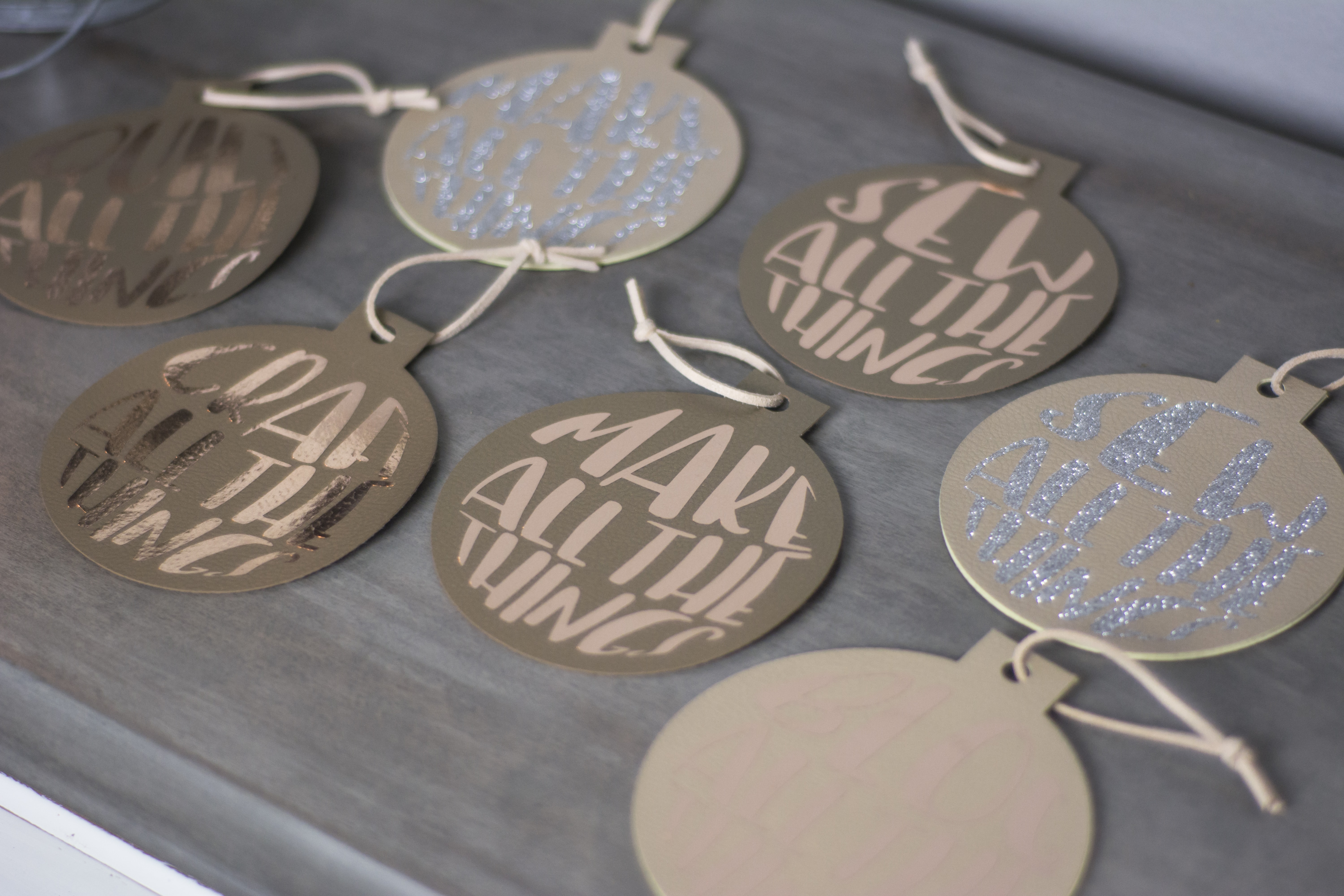 Make these adorable "Maker" DIY Leather Christmas ornaments. Includes free svg cut files - with cute sayings like "make all the things" - great gift ideas for Makers! #cricutmade #cricut #leatherornaments #christmasornamentDIY #DIYChristmasOrnaments