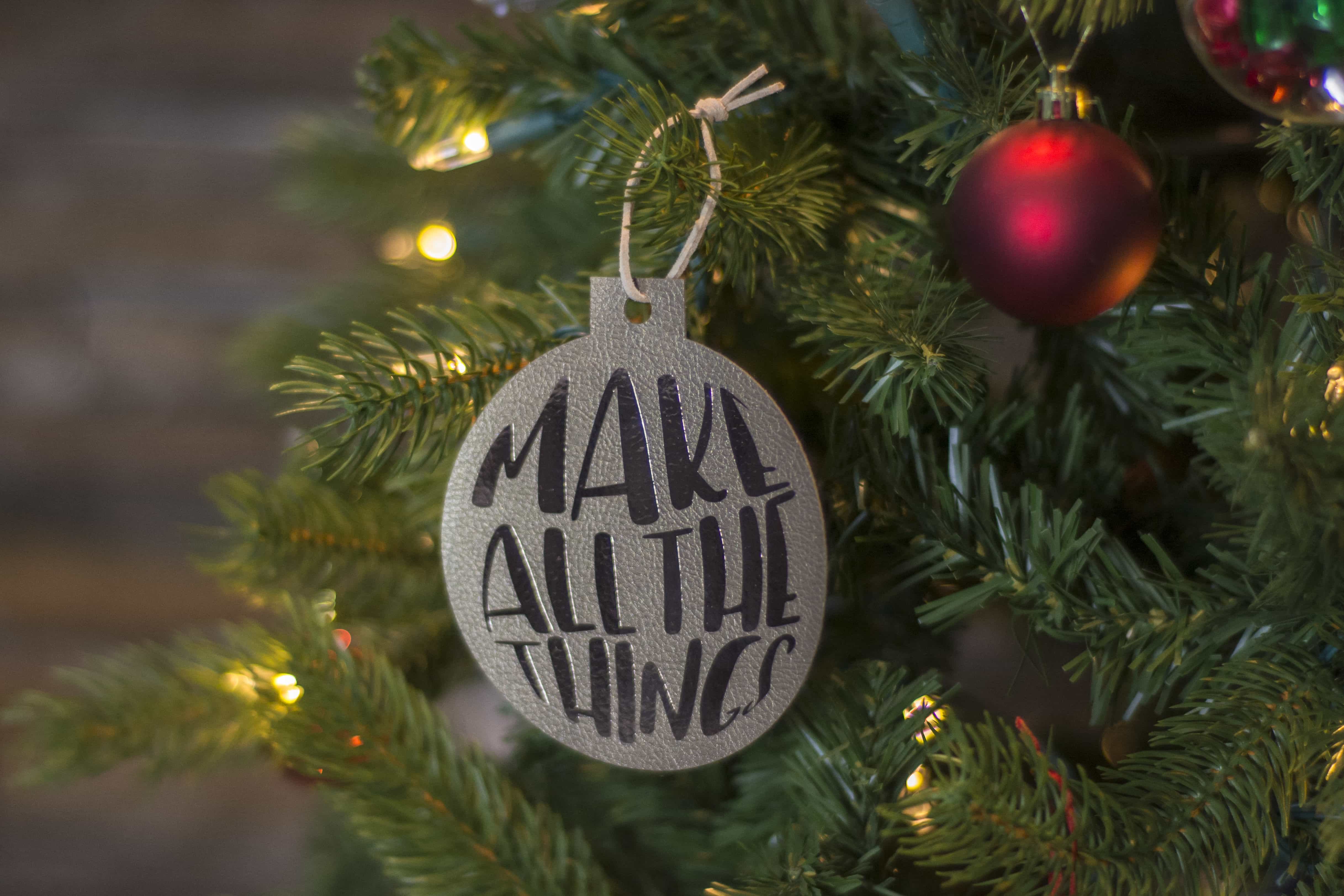 Make these adorable "Maker" DIY Leather Christmas ornaments. Includes free svg cut files - with cute sayings like "make all the things" - great gift ideas for Makers! #cricutmade #cricut #leatherornaments #christmasornamentDIY #DIYChristmasOrnaments