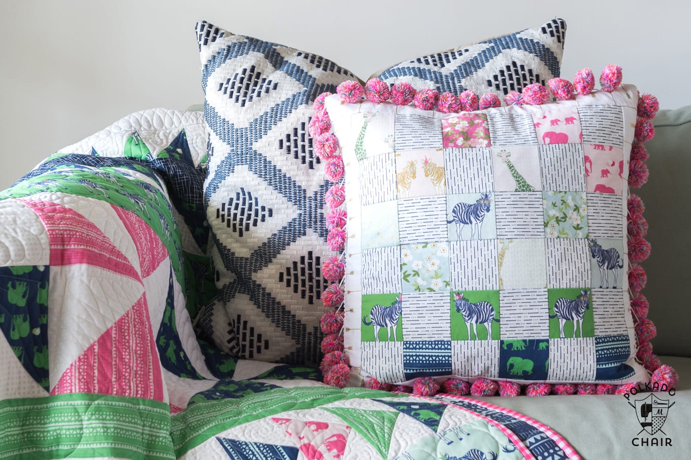 Free sewing pattern for a pom pom patchwork pillow. Uses a fun cheater way to make the points match up- Free pillow pattern