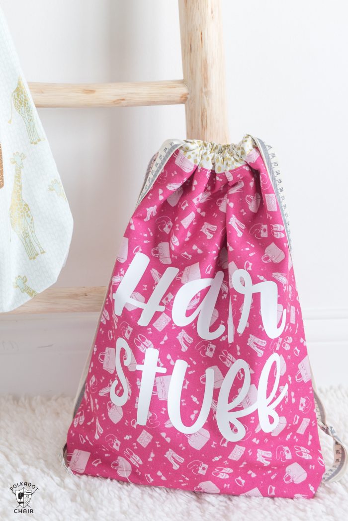 Free tutorial and Lined Drawstring Bag Sewing Pattern - how to sew a reversible drawstring bag and add cute sayings to the front! Includes free cricut cut file downloads #sewing #sewingpattern #drawstringbag #laundrybag #cricut #cricutmade #ad