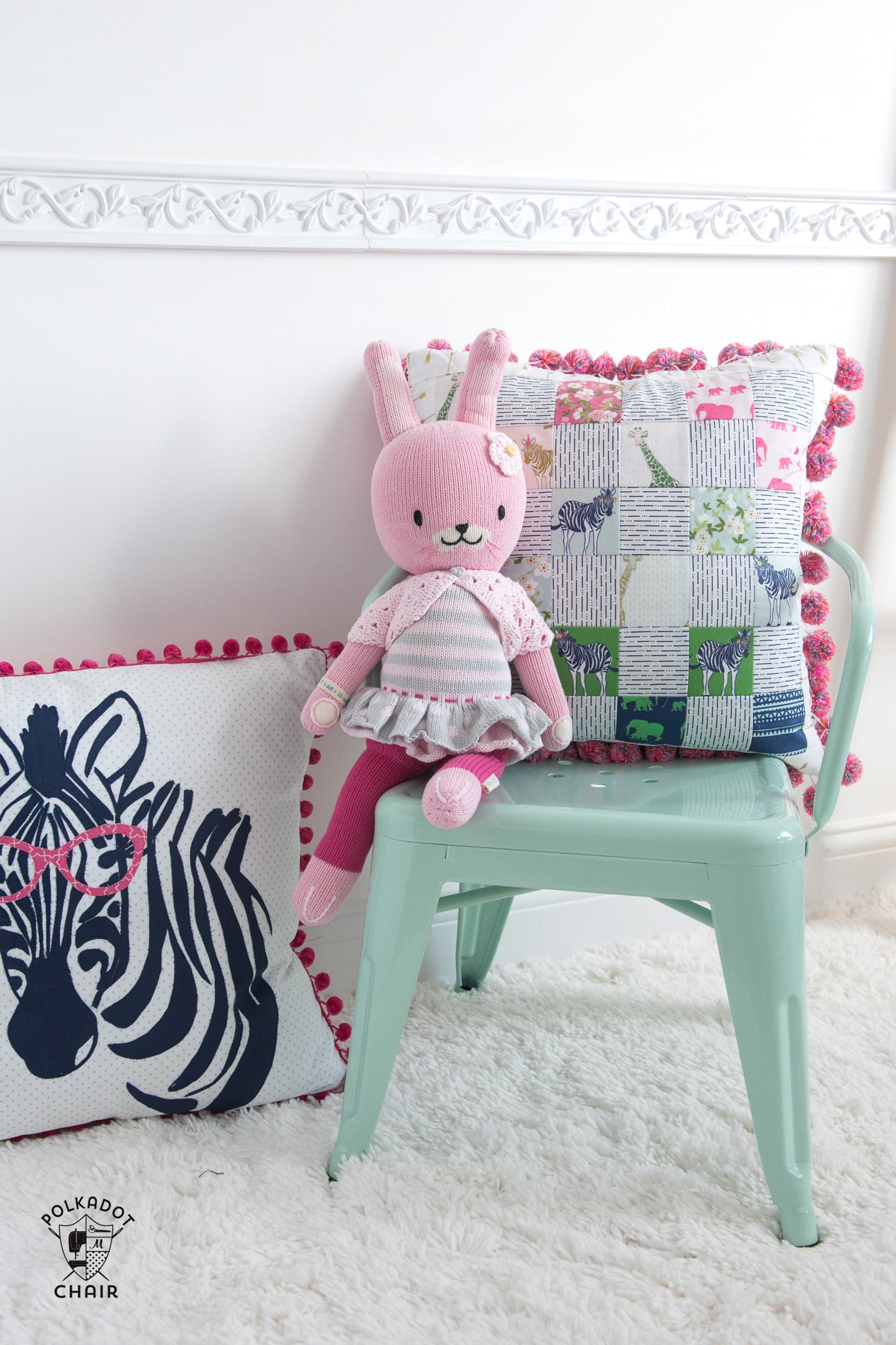 Free sewing pattern for a pom pom patchwork pillow. Uses a fun cheater way to make the points match up- Free pillow pattern