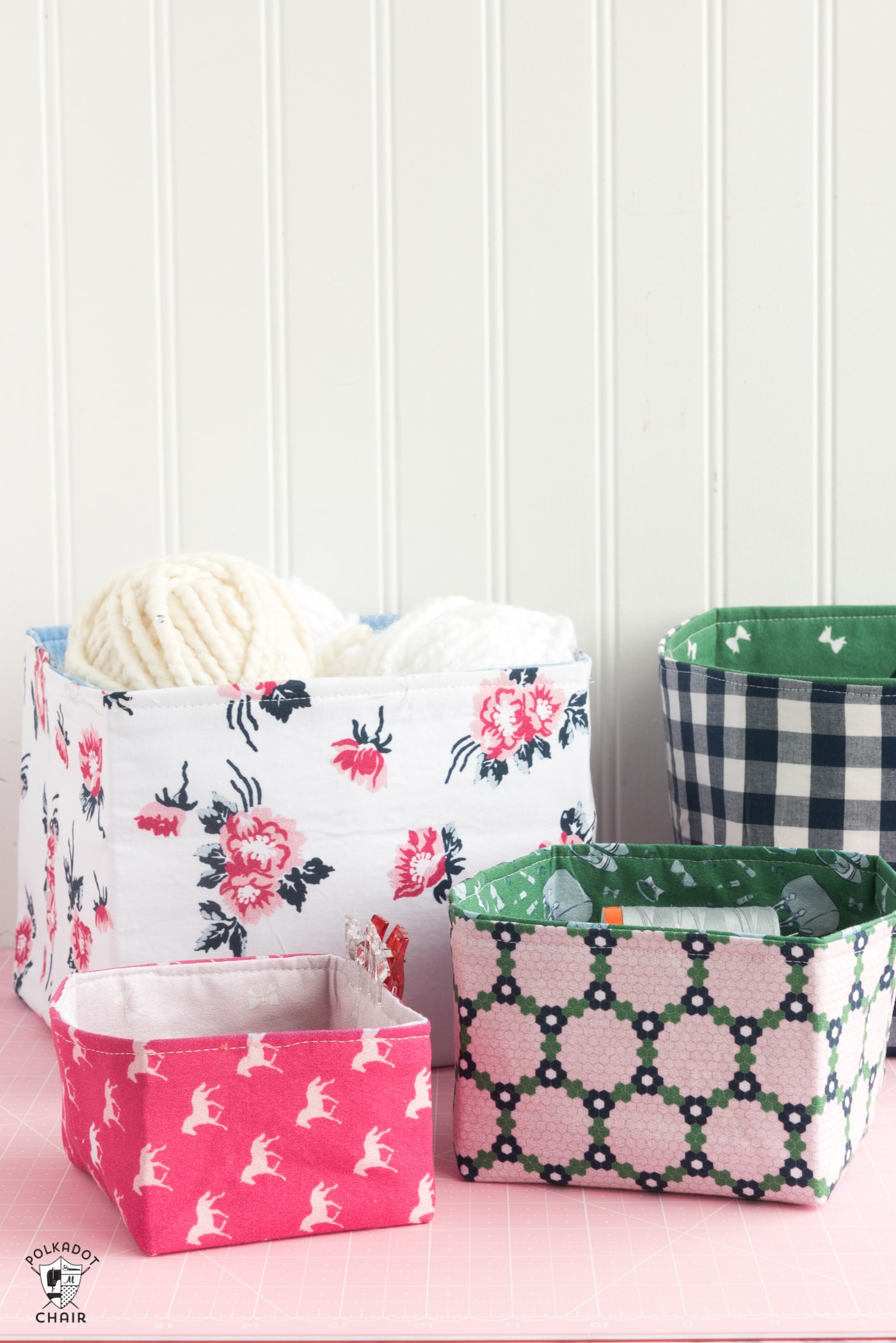 Fabric baskets on pink table