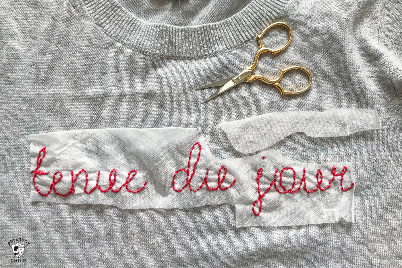 Learn how to make a DIY Embroidered sweater with a fun french quote on it. Includes free embroidery pattern for the quote. A clever way to refashion an old sweater. #DIYEmbroidery #DIYFashion #embroideredsweater #tutorial