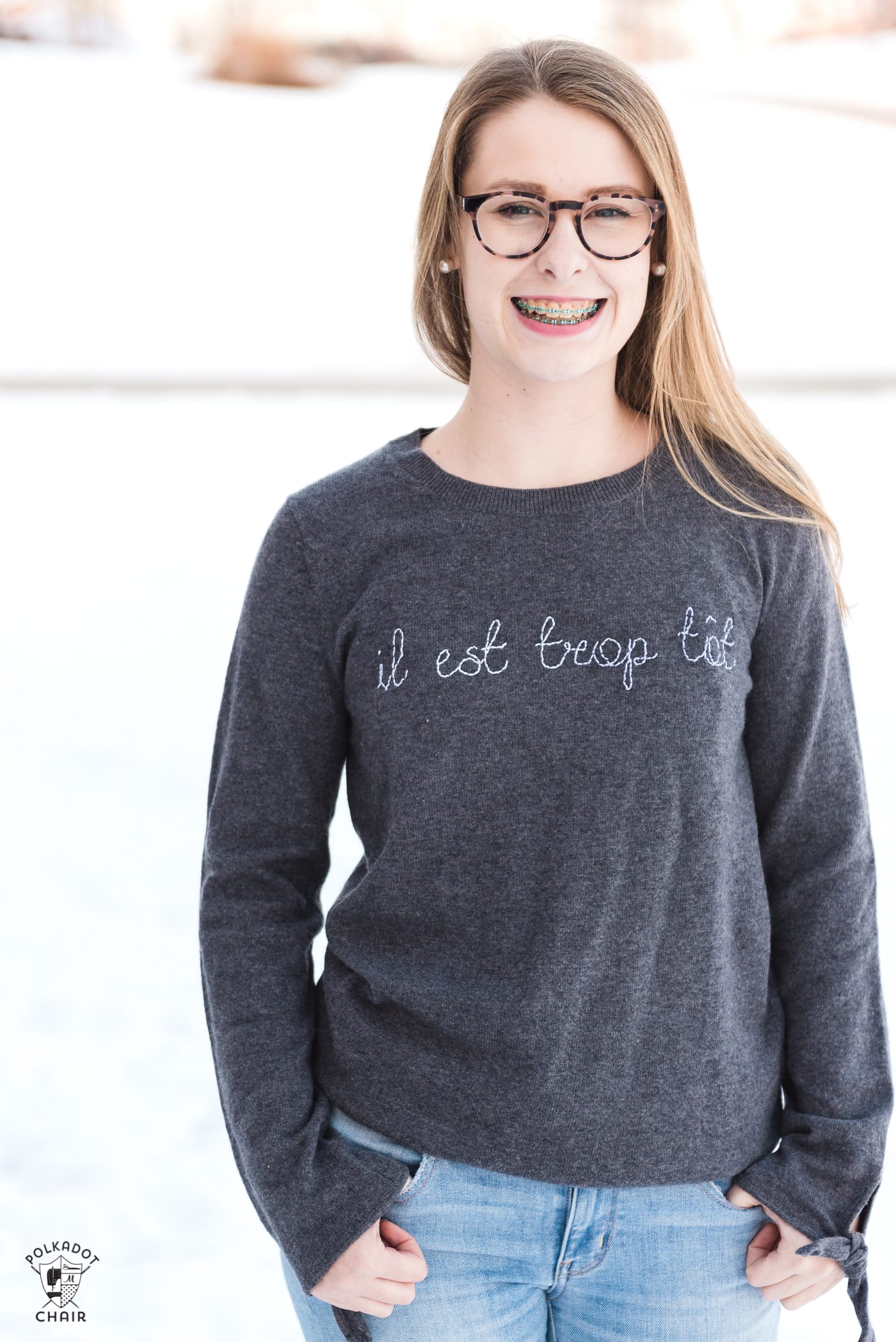 Learn how to make a DIY Embroidered sweater with a fun french quote on it. Includes free embroidery pattern for the quote. A clever way to refashion an old sweater. #DIYEmbroidery #DIYFashion #embroideredsweater #tutorial