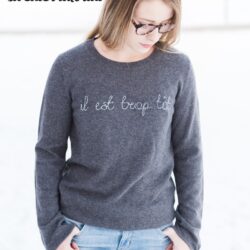 Learn how to make a DIY Embroidered sweater with a fun french quote on it. Includes free embroidery pattern for the quote. A clever way to refashion an old sweater. #DIYEmbroidery #DIYFashion #embroideredsweater #tutorial