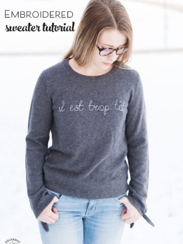 Learn how to make a DIY Embroidered sweater with a fun french quote on it. Includes free embroidery pattern for the quote. A clever way to refashion an old sweater. #DIYEmbroidery #DIYFashion #embroideredsweater #tutorial