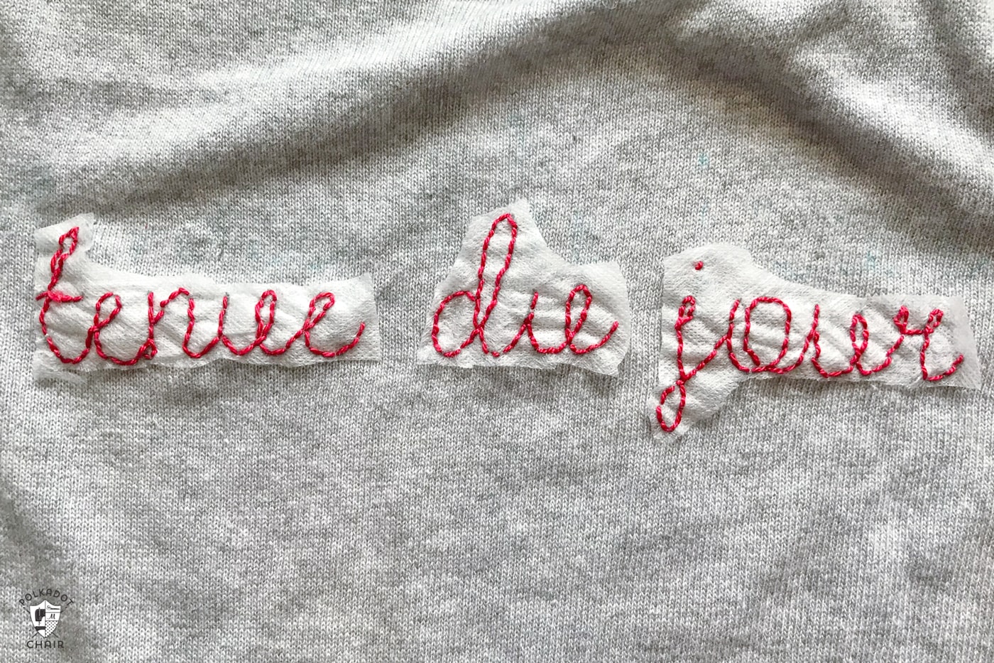 Learn how to make a DIY Embroidered sweater with a fun french quote on it. Includes free embroidery pattern for the quote. A clever way to refashion an old sweater. #DIYEmbroidery #DIYFashion #embroideredsweater #tutorial