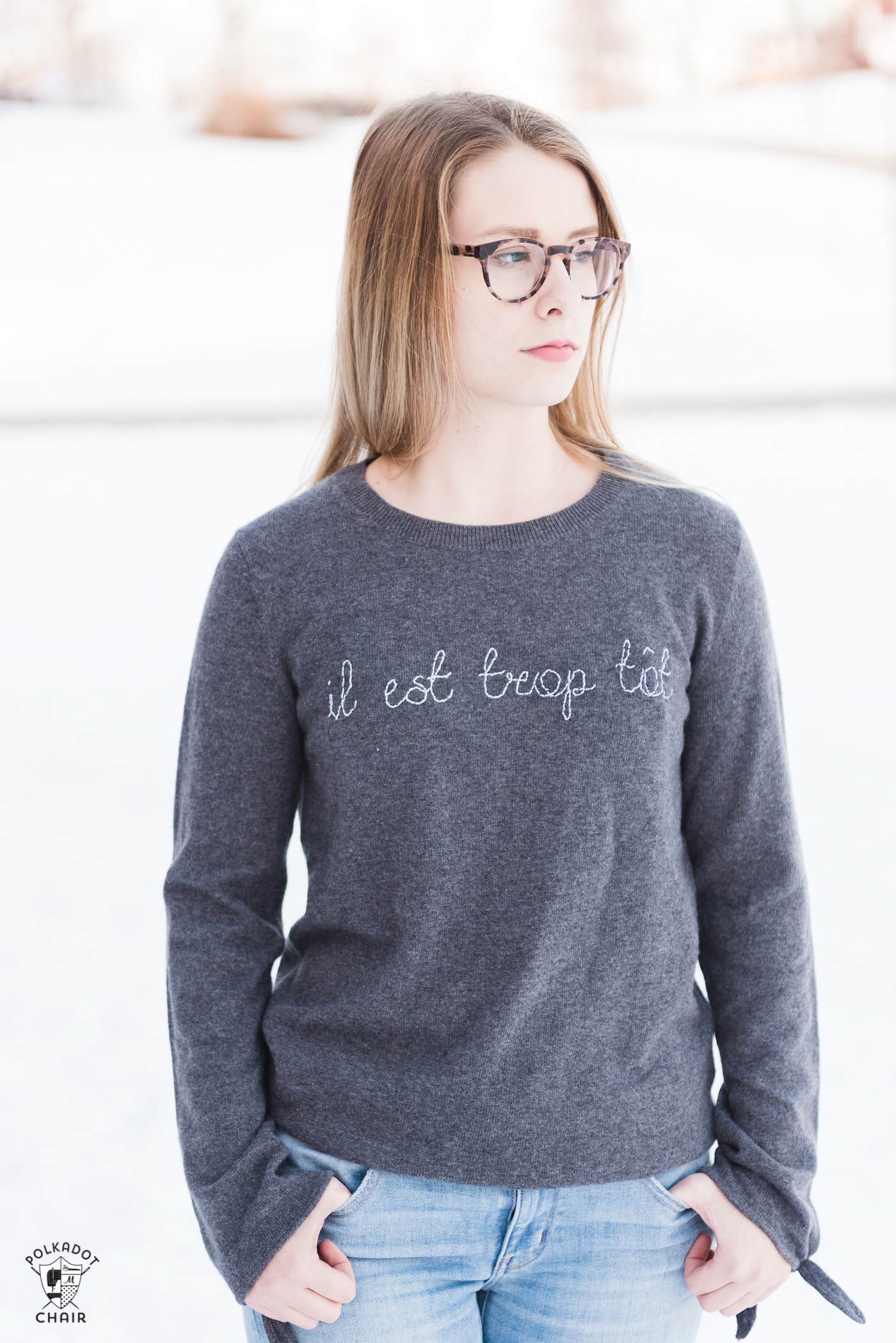 Learn how to make a DIY Embroidered sweater with a fun french quote on it. Includes free embroidery pattern for the quote. A clever way to refashion an old sweater. #DIYEmbroidery #DIYFashion #embroideredsweater #tutorial