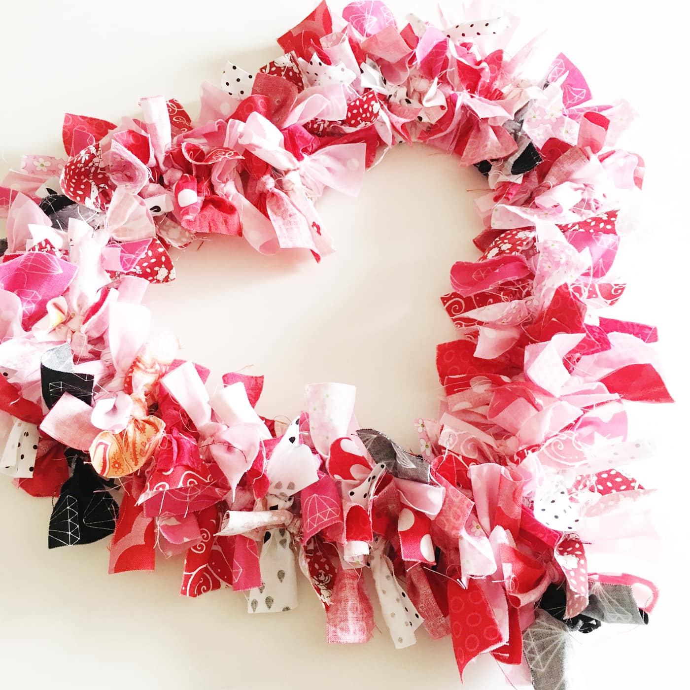 How to make a Valentine's Heart Fabric Rag Wreath- a cute Valentine's Day Craft idea. Rag Wreath Tutorial #ValentinesDayCrafts #DIYWreath #RagWreath #FabricWreathTutorial