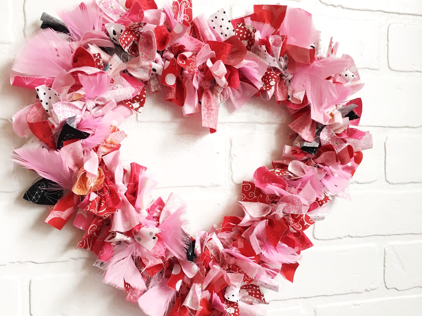 How to make a Valentine's Heart Fabric Rag Wreath- a cute Valentine's Day Craft idea. Rag Wreath Tutorial #ValentinesDayCrafts #DIYWreath #RagWreath #FabricWreathTutorial