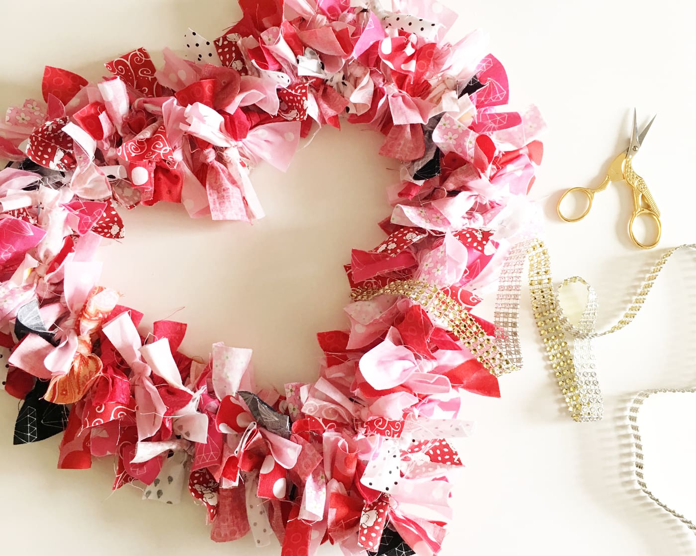 How to make a Valentine's Heart Fabric Rag Wreath- a cute Valentine's Day Craft idea. Rag Wreath Tutorial #ValentinesDayCrafts #DIYWreath #RagWreath #FabricWreathTutorial