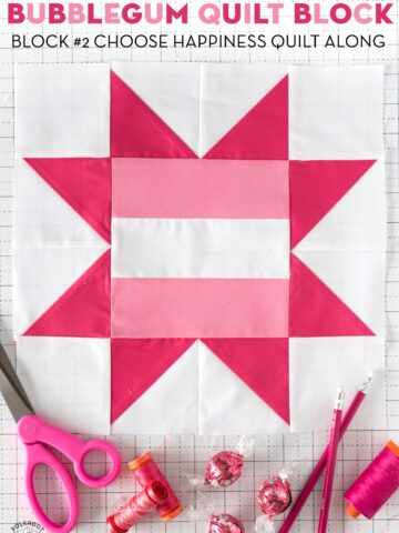 Light pink and dark pink Quilt block on white table.