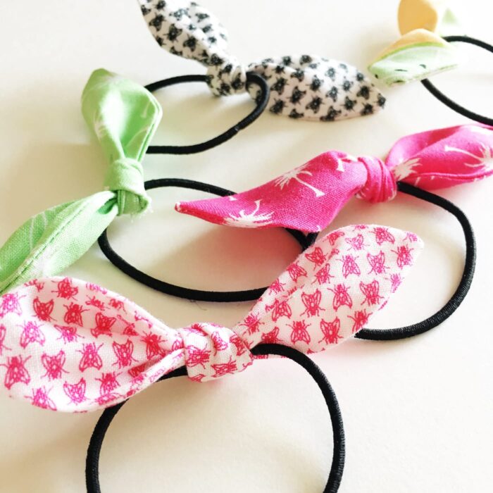 pink and green hair ties on white table 