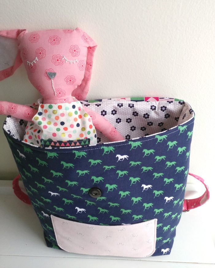 Learn how to sew a mini backpack with this cute toddler backpack pattern. Stitched up with Derby Day fabrics from Riley Blake Designs #minibackpack #toddlerbackpack #smallbackpack #backpacksewingpattern