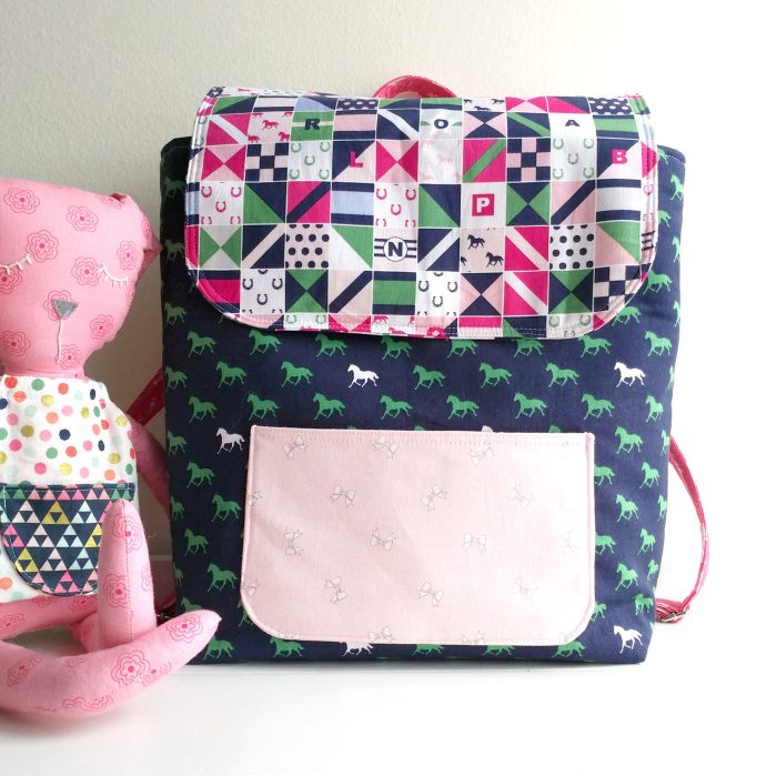 Learn how to sew a mini backpack with this cute toddler backpack pattern. Stitched up with Derby Day fabrics from Riley Blake Designs #minibackpack #toddlerbackpack #smallbackpack #backpacksewingpattern