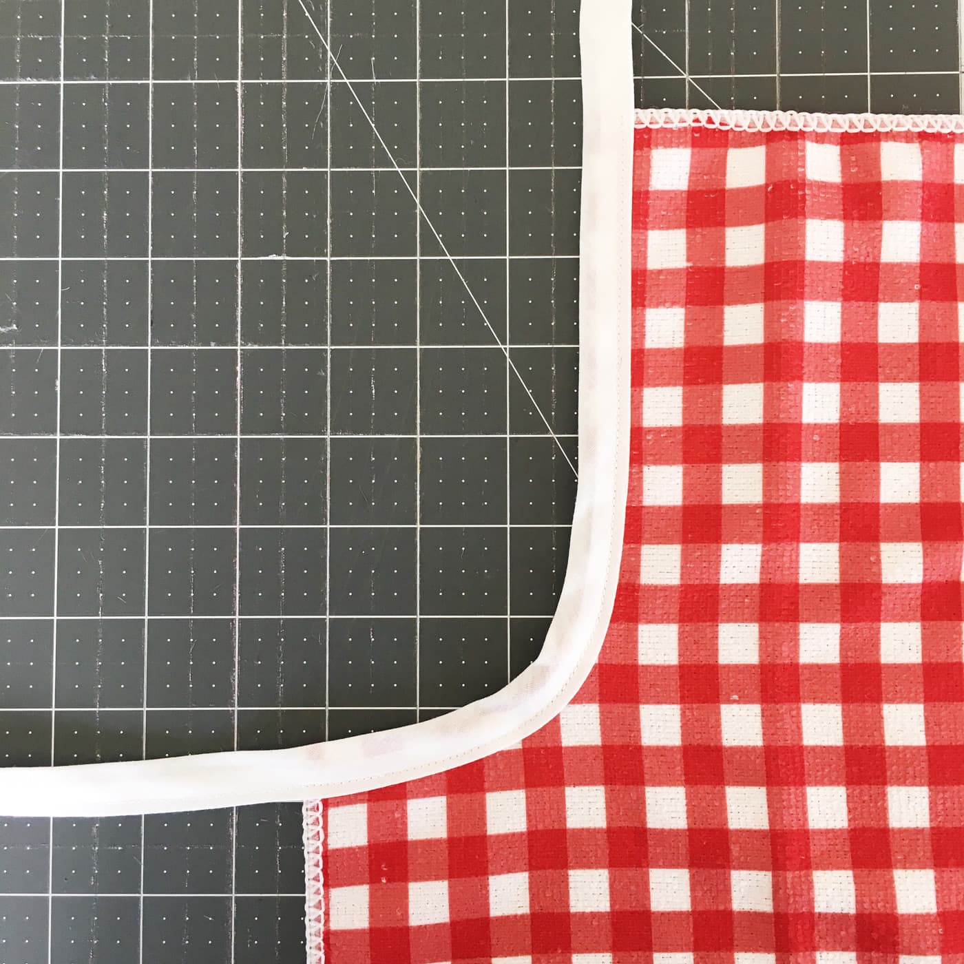 Attaching bias tape to the edge of the kids apron
