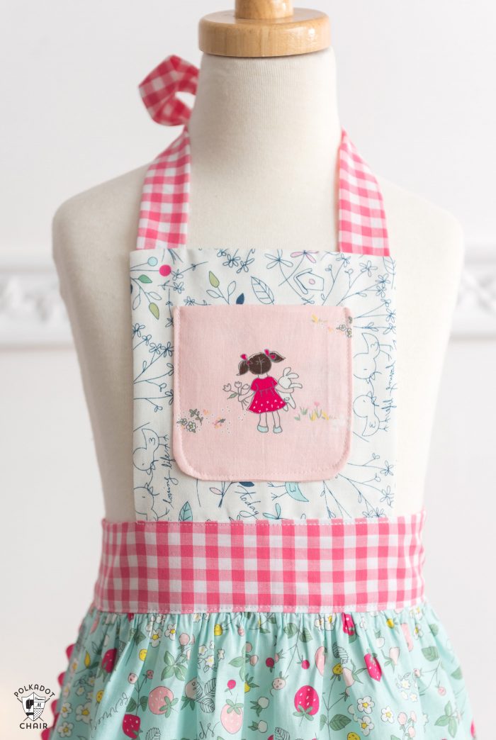 child's apron on dress form