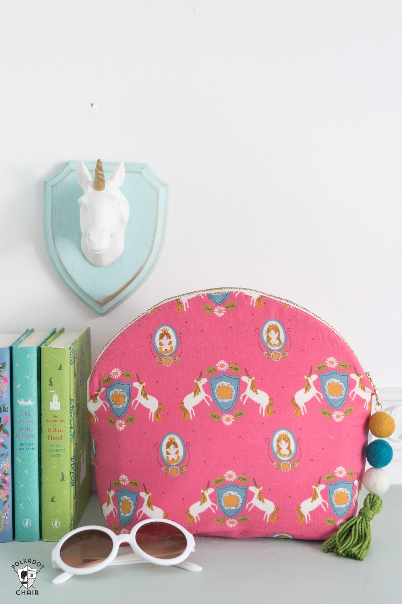 makeup bag and books on a table