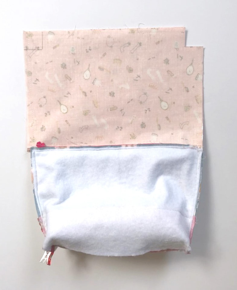 fabric for makeup bag with plastic lining on white tabletop