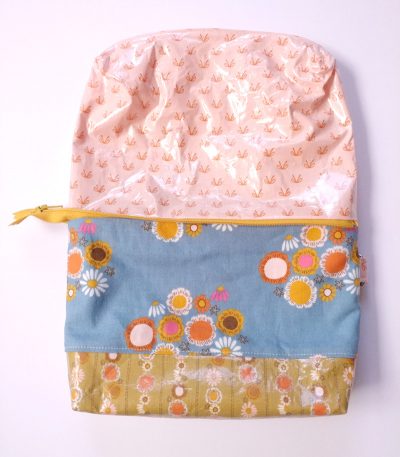 fabric for makeup bag with plastic lining on white tabletop