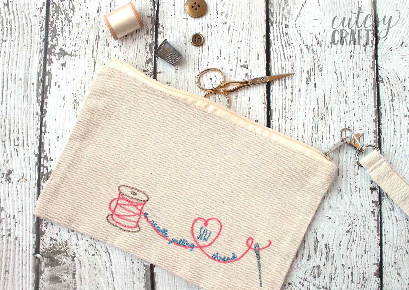 Hand embroidered zip bag on white tabletop