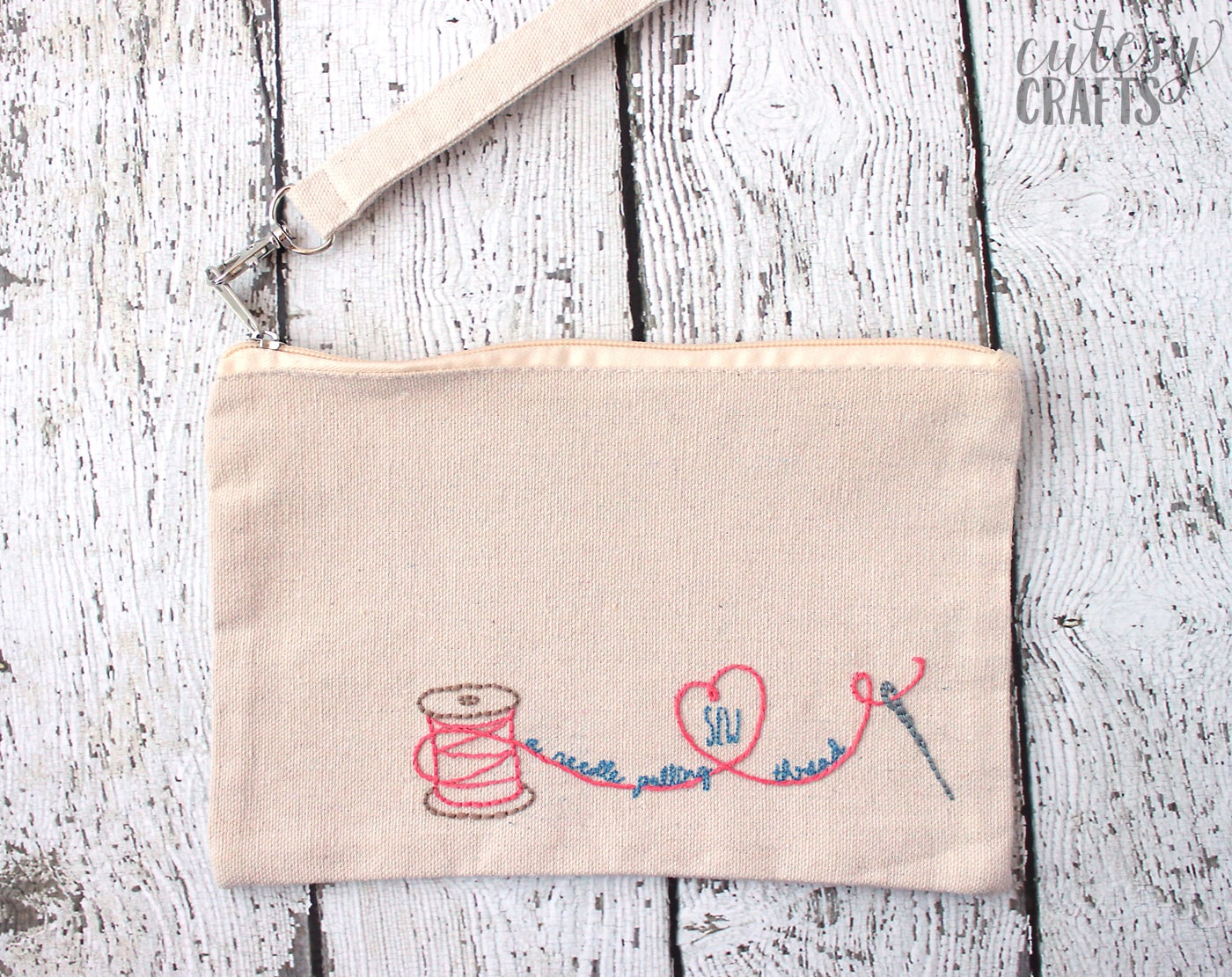 Hand embroidered zip bag on white tabletop