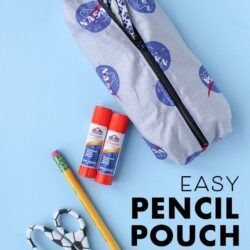 pencil pouch with glue stick and pencil on blue background