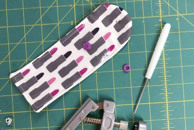 lip gloss case pieces on green cutting mat