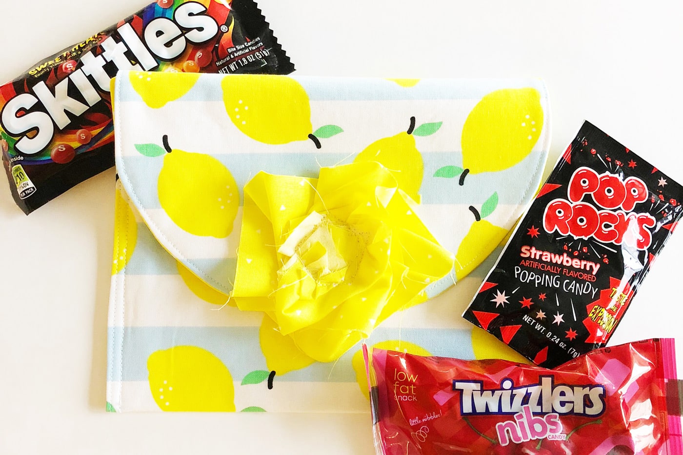 Lemon themed pouch next to candy