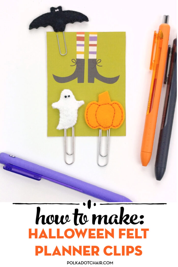Halloween planner clips on white table with pens