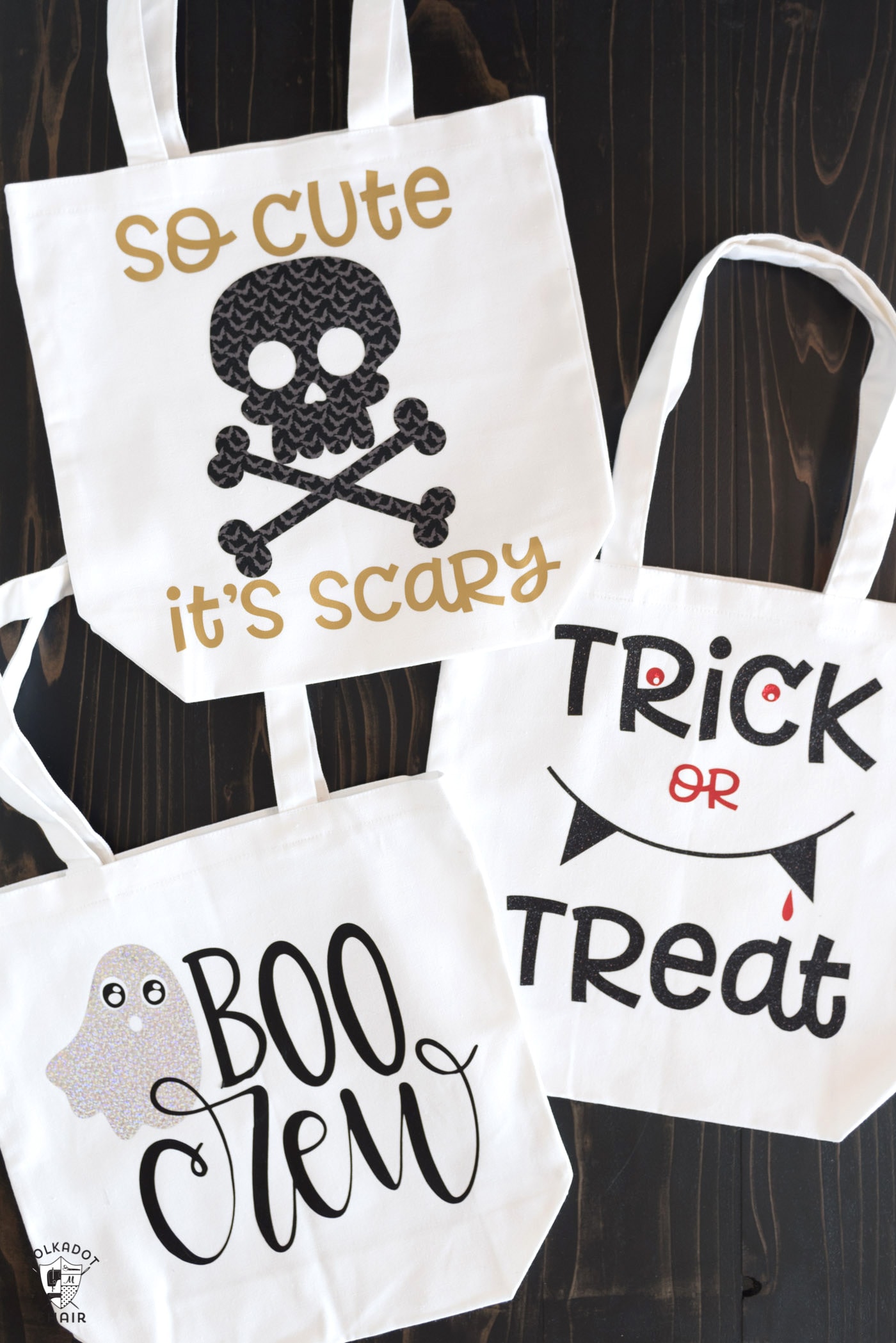 diy trick or treat bags on wood table, white canvas bags with fabric and cricut decals applied