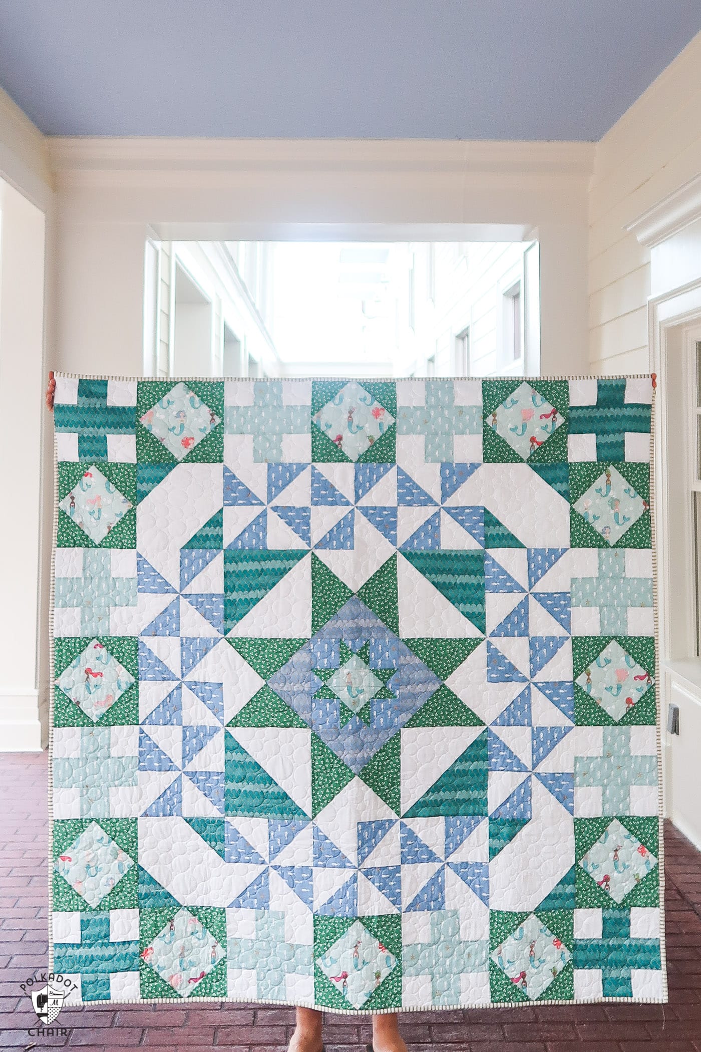 blue and green quilt under portico outdoors