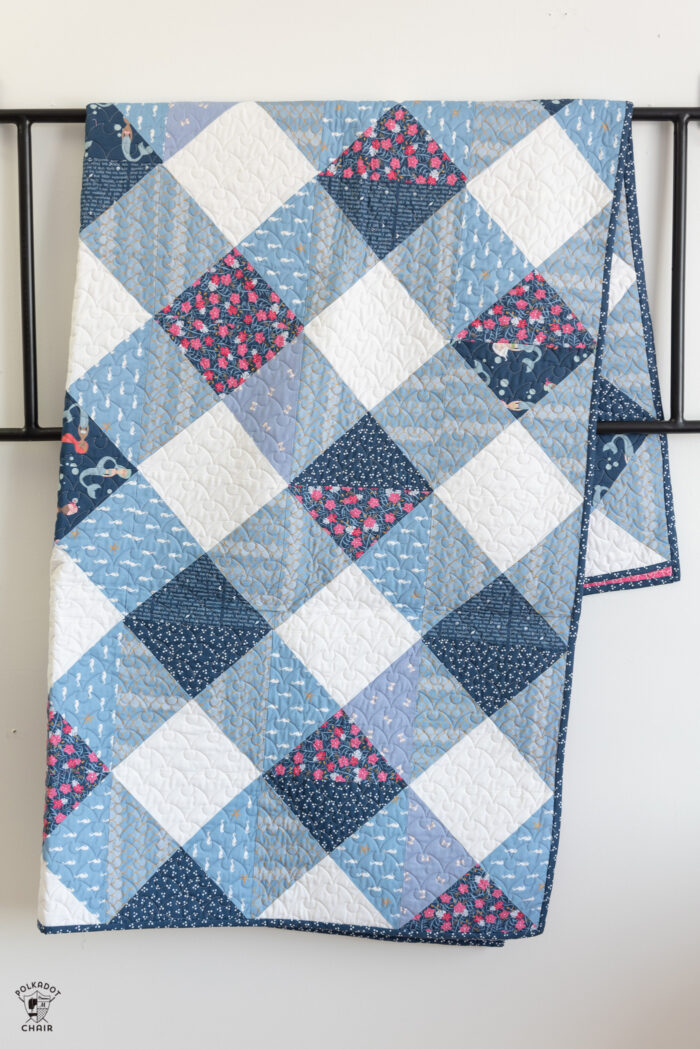 Gingham quilt pattern on white wall