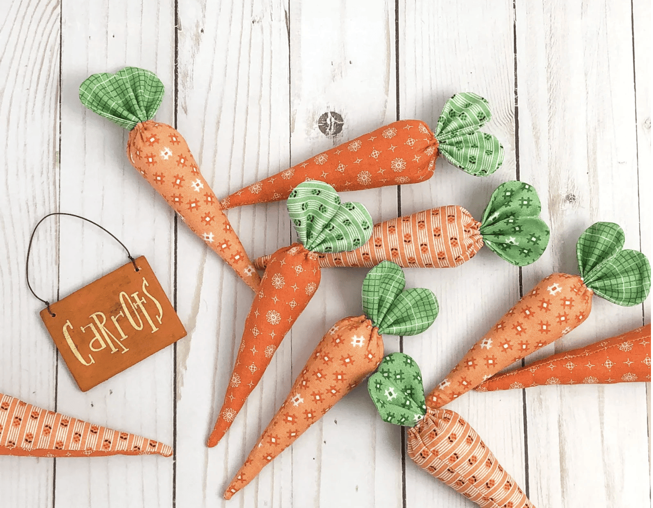 Orange fabric carrots on white table