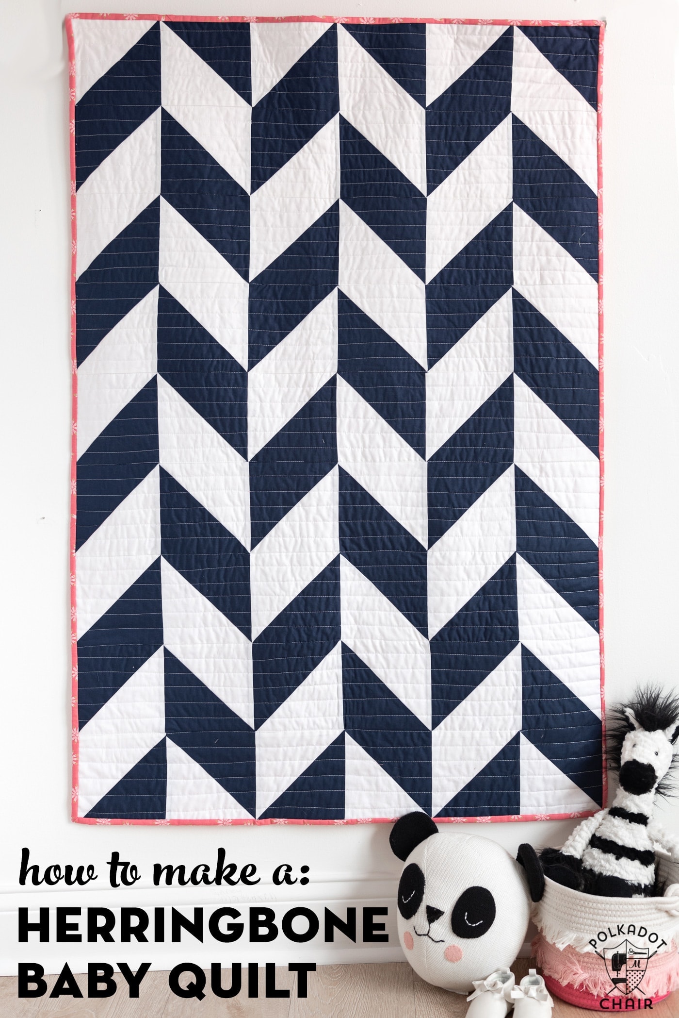 navy and white herringbone quilt on white wall